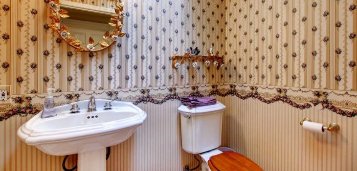 simple bathroom with patterned tiles and funky accent for the mirror